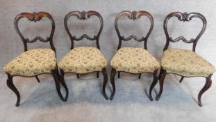 A set of four Victorian rosewood balloon back dining chairs H.84cm