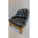 A low club tub chair in black buttoned faux leather. H.75cm (one button missing)
