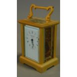 A gilt metal cased carriage clock marked Nathan and Co. 12x6cm