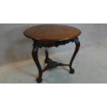 A 19th century Continental carved oak swivel action trefoil flap centre table. 74x82x82cm