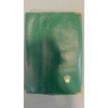A green wallet embossed and inscribed Montres Rolex and with the Rolex logo. 16.5x11.5cm