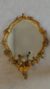 A 19th century gilt framed leaf and foliate decorated 3 branch girandole with oval plate. 92x65cm