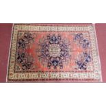 A Tafresh rug, central pole medallion with repeating petal motifs on a rouge field guarded by a