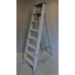 A vintage distressed painted set of step ladders. H.194cm