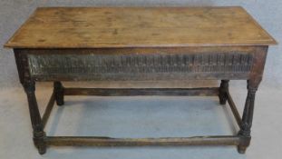 A 17th century oak console table with later top above carved frieze with turned stretchered