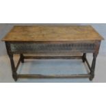 A 17th century oak console table with later top above carved frieze with turned stretchered