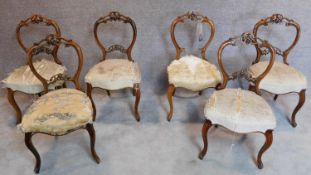 A set of six Victorian carved walnut balloon back dining chairs. H.89cm (one splat broken but