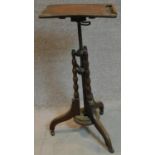 A mid Victorian burr walnut adjustable and articulated music stand on bobbin turned tripod supports.