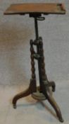 A mid Victorian burr walnut adjustable and articulated music stand on bobbin turned tripod supports.