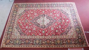 A central Persian Kashan carpet with central double pendant medallion and repeating spandrels and