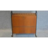 A 1960's vintage teak fitted drinks trolley on casters. 66x62cm