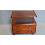 A 1970's vintage teak telephone table fitted two drawers on casters. 58x63x47cm