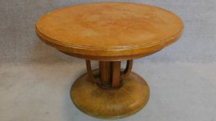 A Continental Art Deco oak circular centre table. 66x102cm