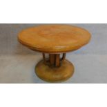 A Continental Art Deco oak circular centre table. 66x102cm