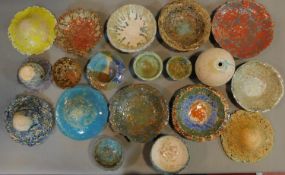 A large and miscellaneous collection of multi coloured glazed Art pottery bowls and dishes.