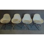 A set of four vintage moulded tub swivel chairs on chrome bases. H.83cm