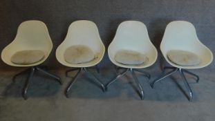 A set of four vintage moulded tub swivel chairs on chrome bases. H.83cm