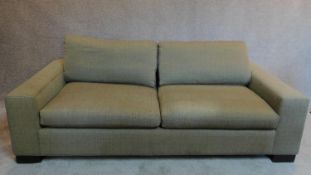 A modern 2 seater sofa in beige upholstery. H.62 W.200 D.105cm