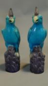 A pair of majolica parrots. H.30cm (damage to one)