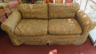 A two seat sofa with Arts and Crafts style tapestry loose covers and feather filled cushions.