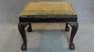 A mid Georgian mahogany stool on cabriole supports with gilt decorated shell motif to each knee.