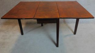 A Georgian mahogany drop flap dining table on square section supports. 73x148x99cm