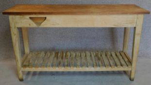 A teak plank top kitchen table with fitted end drawers on distressed base on square tapering