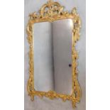 An Florentine style carved giltwood pier mirror with allover fruit and leaf decoration. 150x92cm