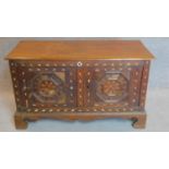 A bone inlaid oak coffer with hinged lid and pair of panel doors on bracket feet. 55x116x50cm