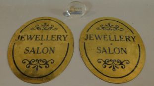 A pair of brass jewellery shop signs and a Moser glass shop display sign. 40x27.5cm