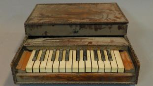 A cased miniature keyboard. 55x47cm (not working A.F.)