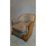 An Art Deco burr walnut leather upholstered cloud back armchair. H.75cm