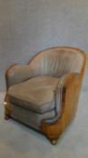 An Art Deco burr walnut leather upholstered cloud back armchair. H.75cm