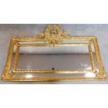 A decorative giltwood wall mirror with carved garland and ribbon cresting. 130x80cm