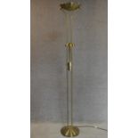 A floor standing uplighter with reading light. H.184cm