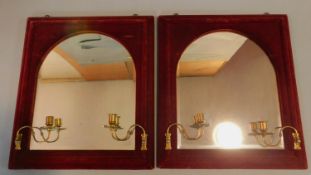 An unusual pair of arched Victorian pier mirrors in red velvet frames fitted with candle sconces.