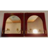 An unusual pair of arched Victorian pier mirrors in red velvet frames fitted with candle sconces.