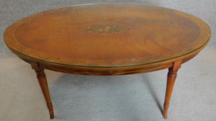 An oval topped handpainted occasional table in the Sheraton style with plate glass top. Signed by ar