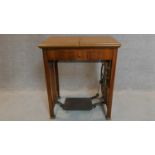 A vintage Frister and Rossman sewing machine in a fitted walnut side table. 80x70x50cm