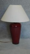 A sang de boeuf table lamp of bulbous form. H.72cm