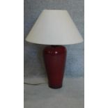 A sang de boeuf table lamp of bulbous form. H.72cm