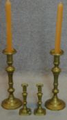 A large pair of 19th century turned brass candlesticks and a similar smaller pair. H.49cm
