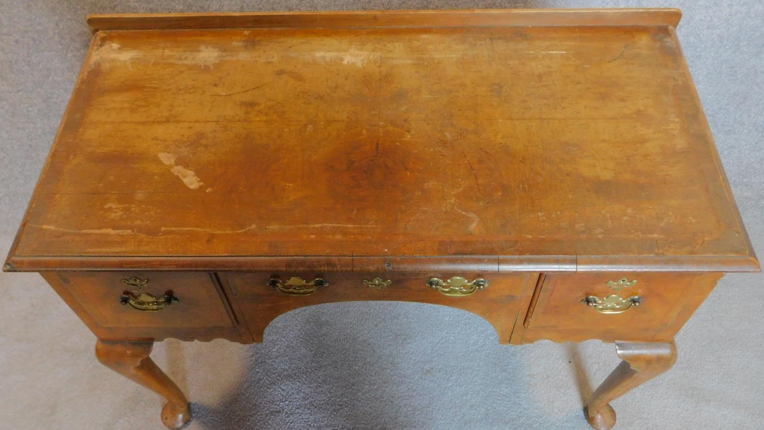 A mid Georgian style walnut and featherbanded lowboy on cabriole supports. 77x106x51cm - Image 4 of 5