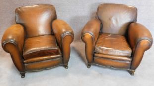 A pair of vintage beech framed leather club armchairs on cabriole feet to front and back. H.80 W.