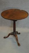 A Georgian Cuban mahogany circular tilt top occasional table with a birdcage action, gun barrel
