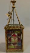 A late 19th century brass cased lantern with leaded stained glass panels. 63x21cm