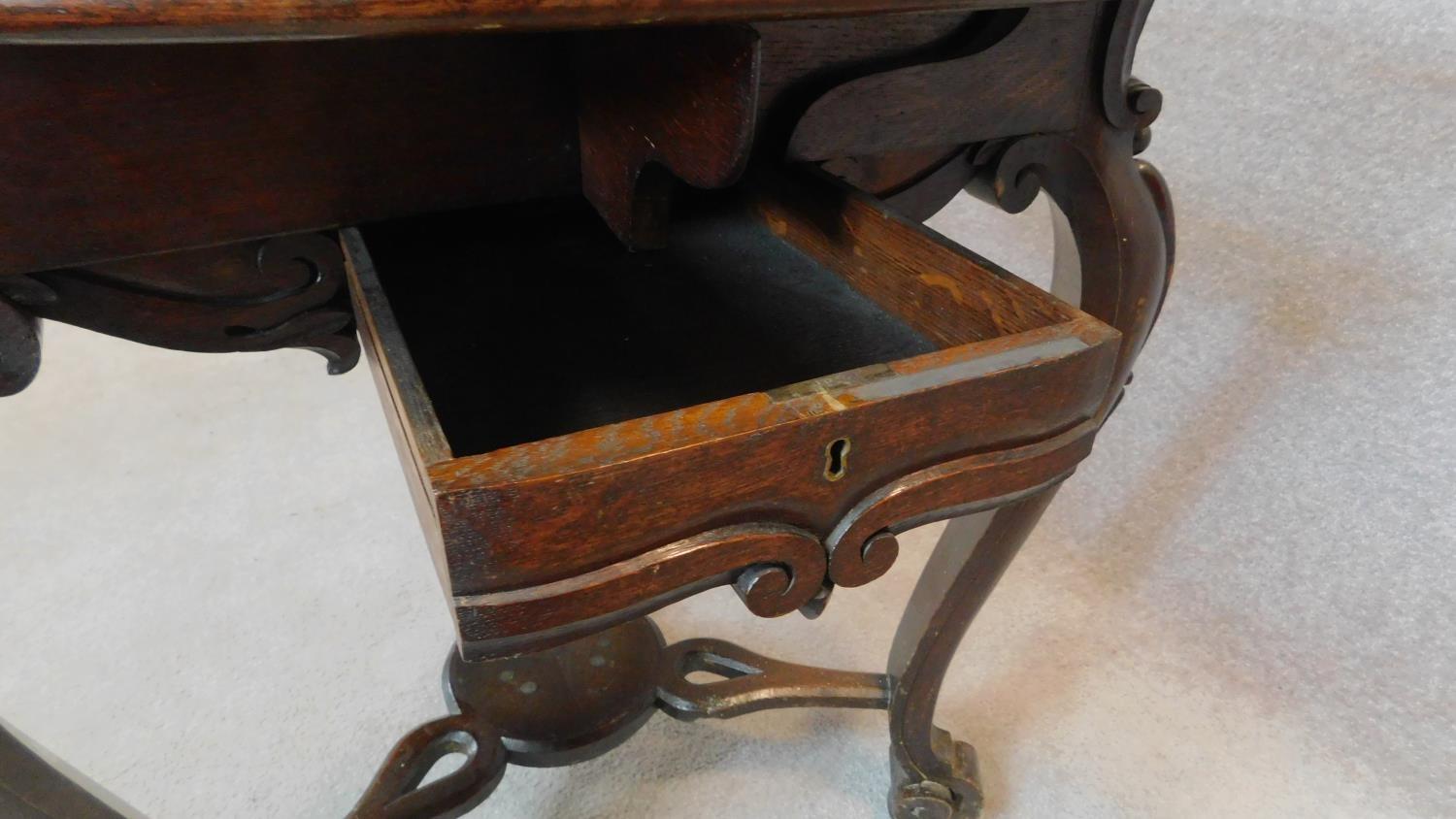 A 19th century Continental carved oak swivel action trefoil flap centre table. 74x82x82cm - Image 6 of 7