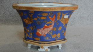 A small painted Chinese planter with goldfish decoration, character marks to base. H.27cm