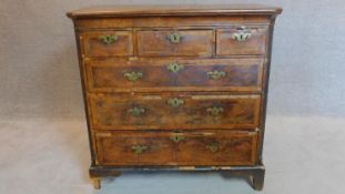 A mid Georgian walnut and featherbanded chest of three short over three long drawers.