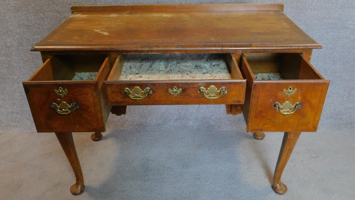 A mid Georgian style walnut and featherbanded lowboy on cabriole supports. 77x106x51cm - Image 2 of 5
